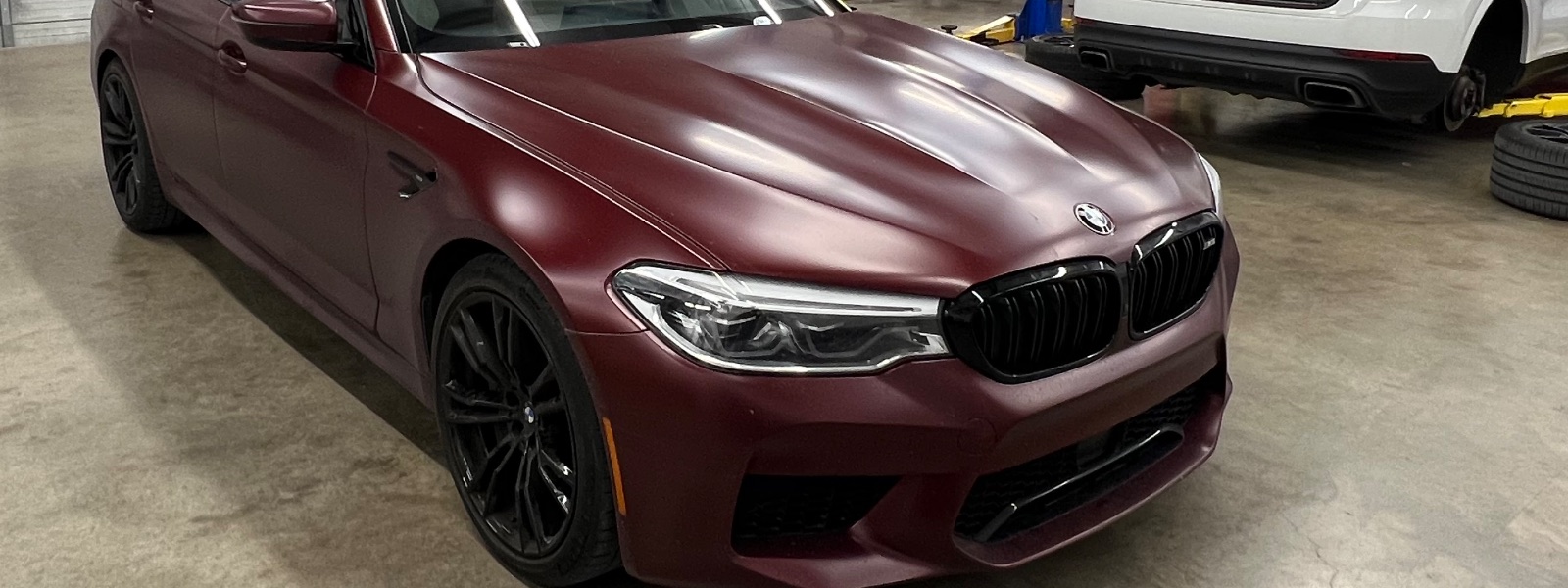 Matte-red BMW M5 in the shop
