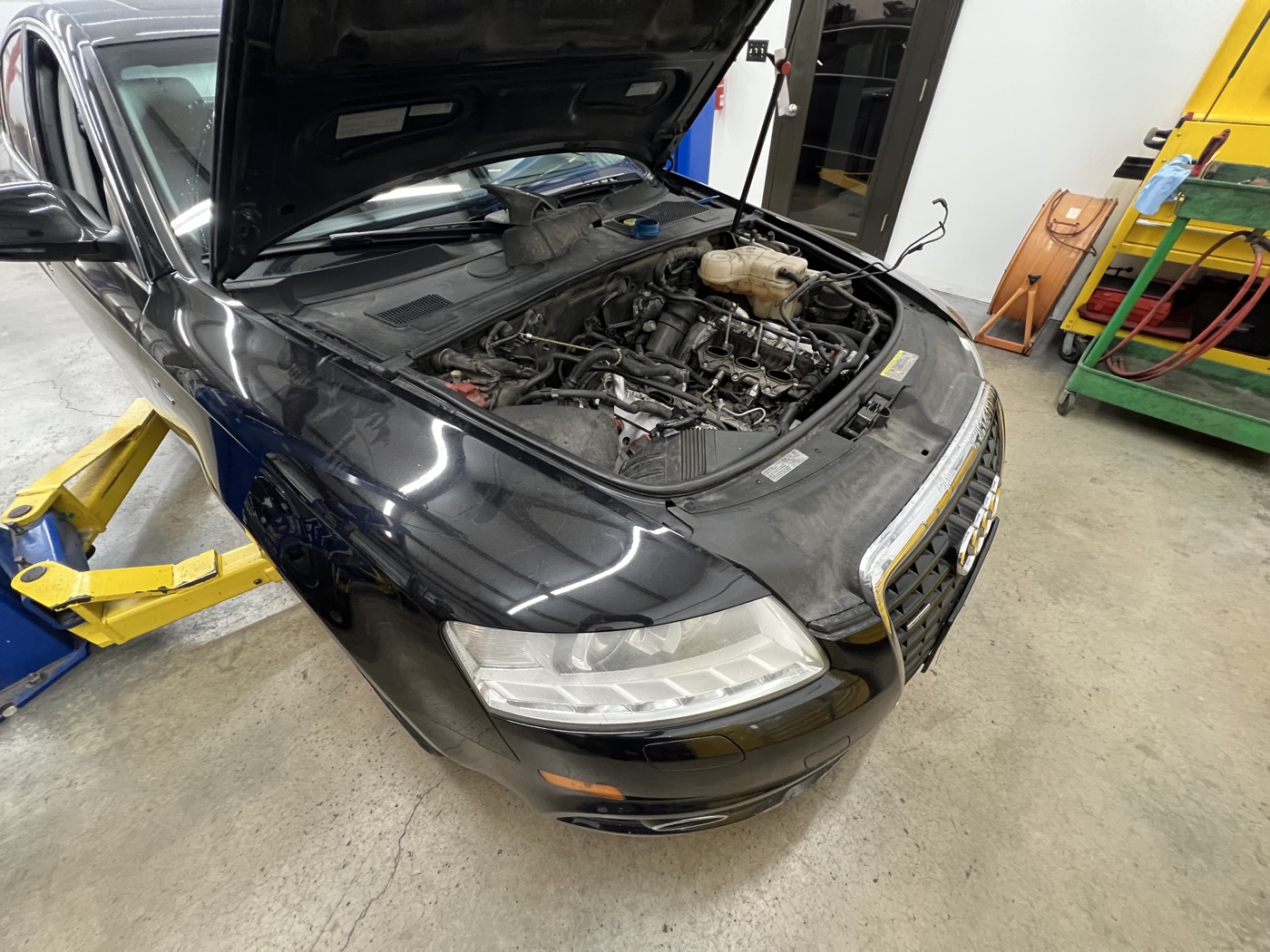 Audi engine bay open during service in the shop