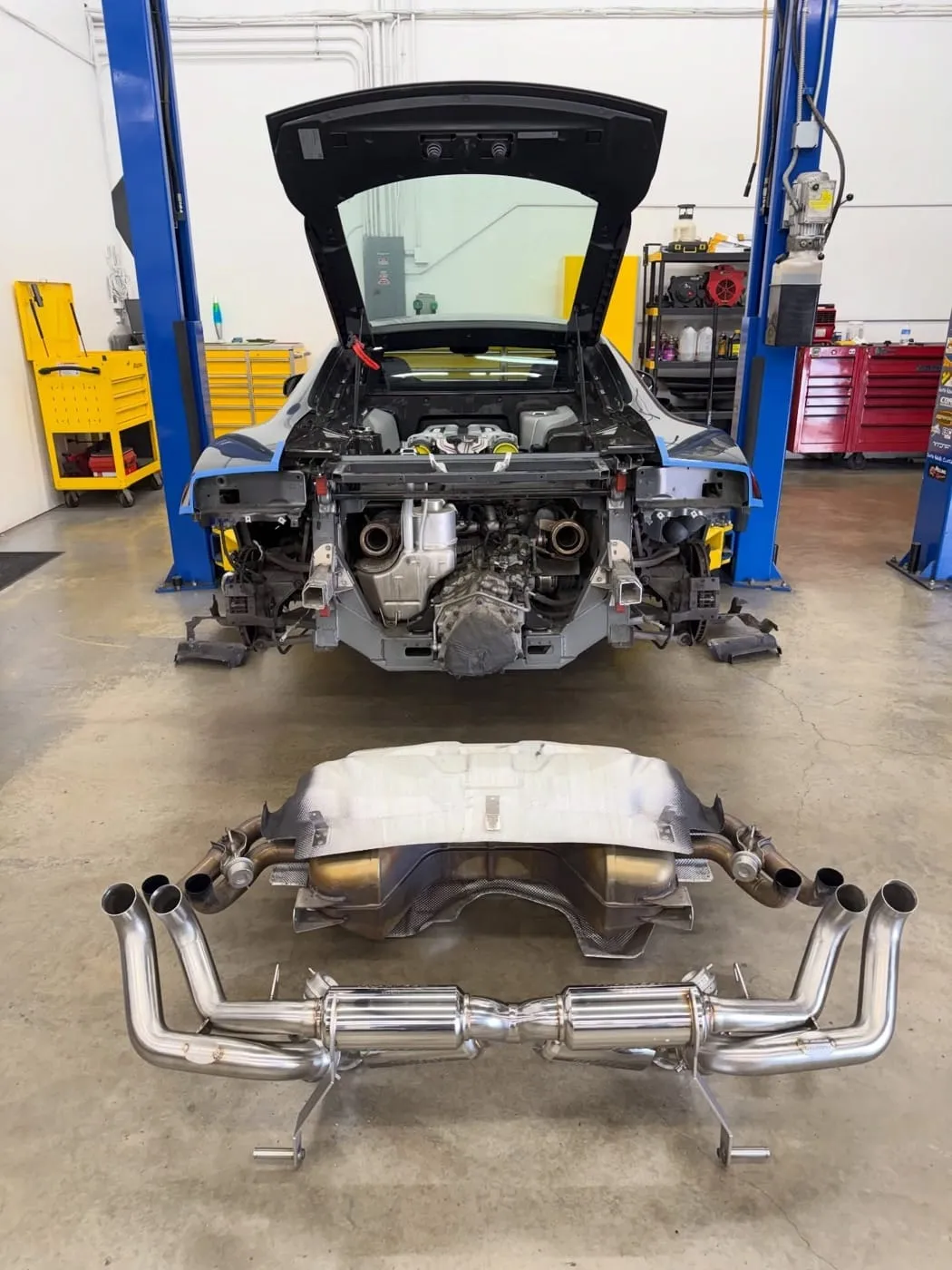 Audi R8 on the lift with its exhaust system laid out