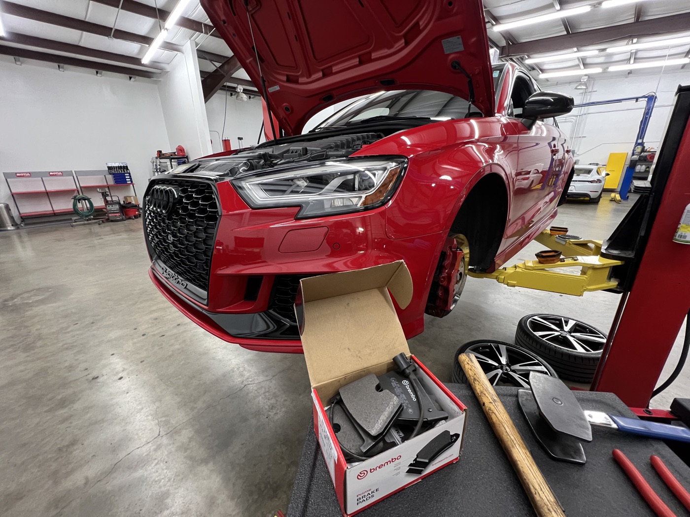 Red Audi RS3 on the lift during a Brembo brake service