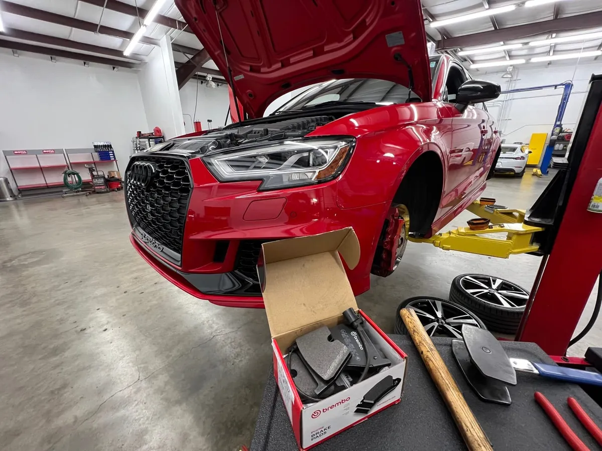 Red Audi RS3 on the lift during a Brembo brake service