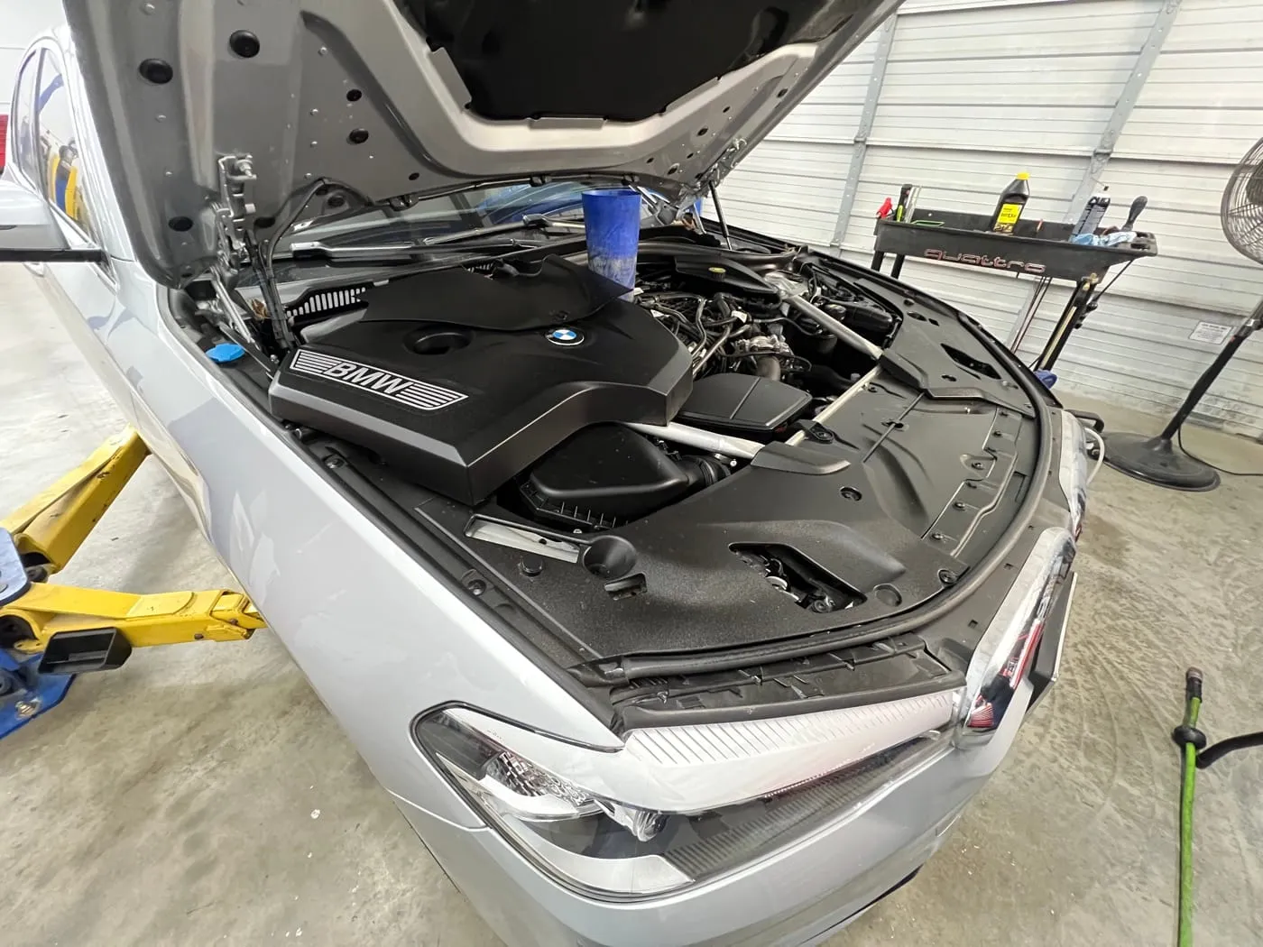 German car engine bay open for an oil leak inspection