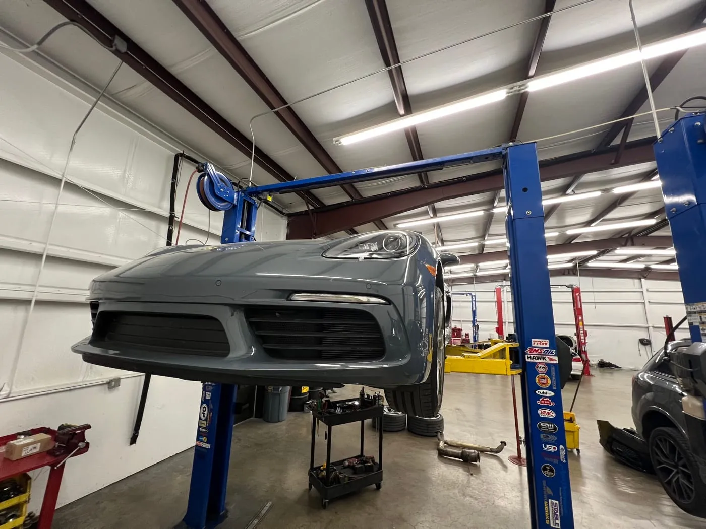 Porsche 718 raised on the shop lift
