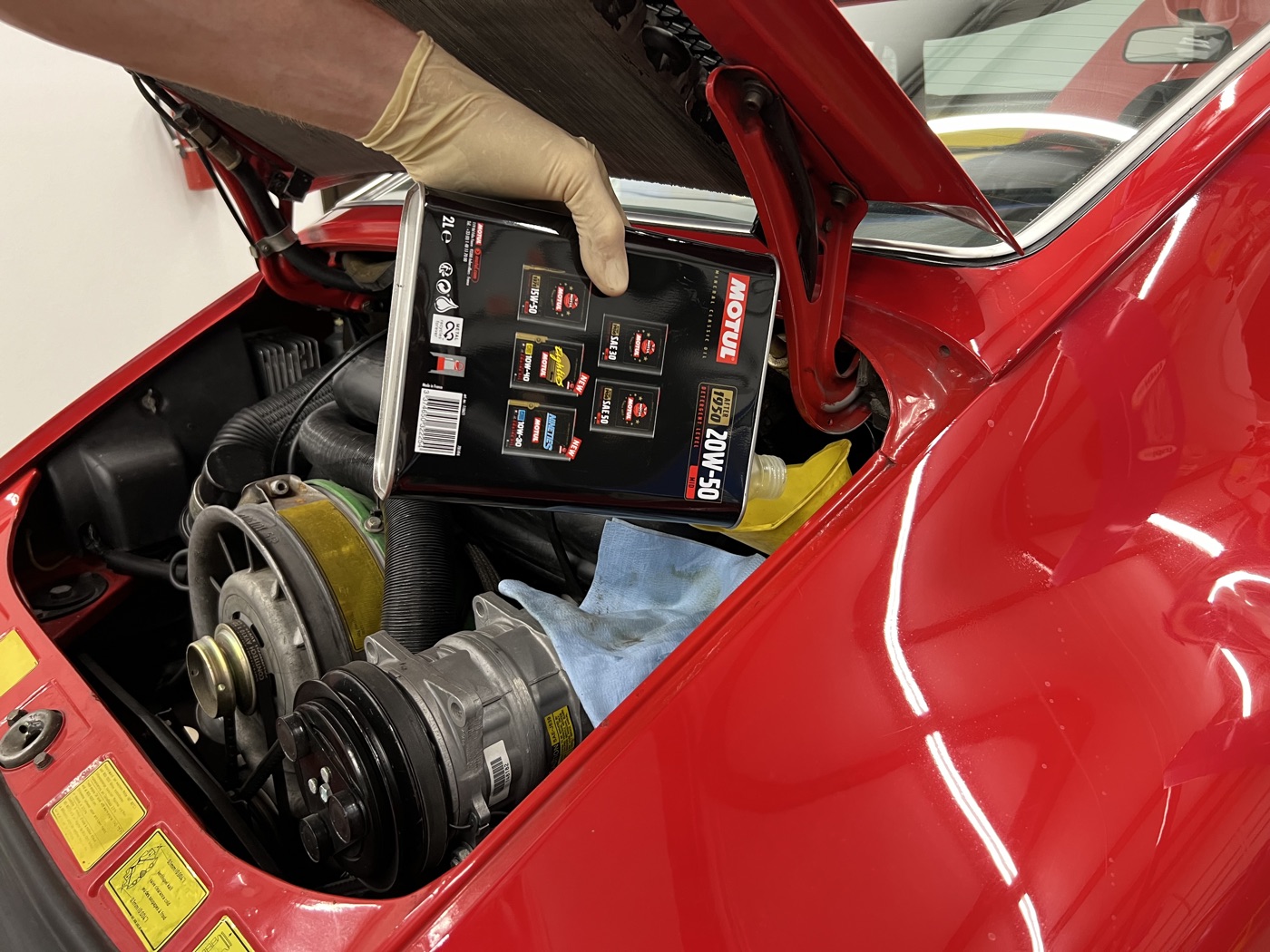 Air-cooled Porsche 911 flat-six engine bay during an oil service