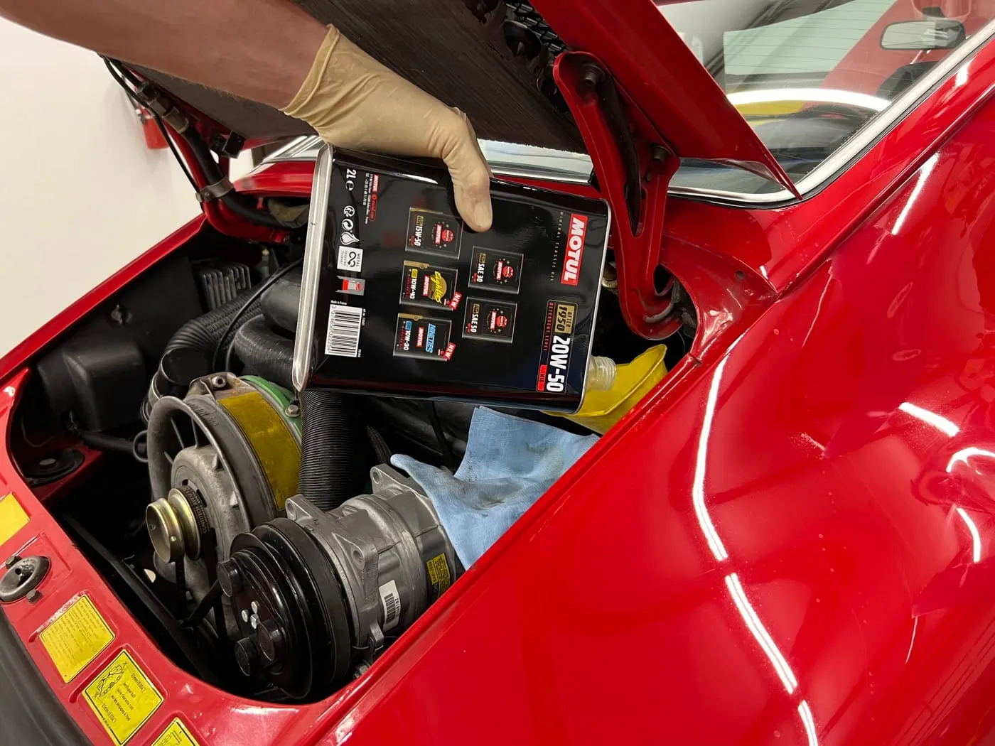 Air-cooled Porsche 911 flat-six engine bay during an oil service