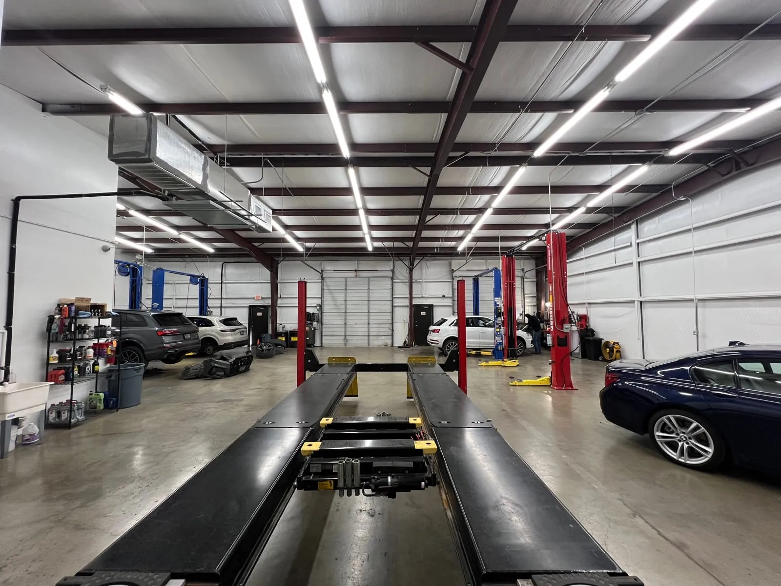 Inside the My German Car SA shop with vehicles on the lifts and alignment rack